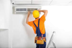 Technician Fixing the Air Conditioning Unit